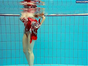 warm polish redhead swimming in the pool